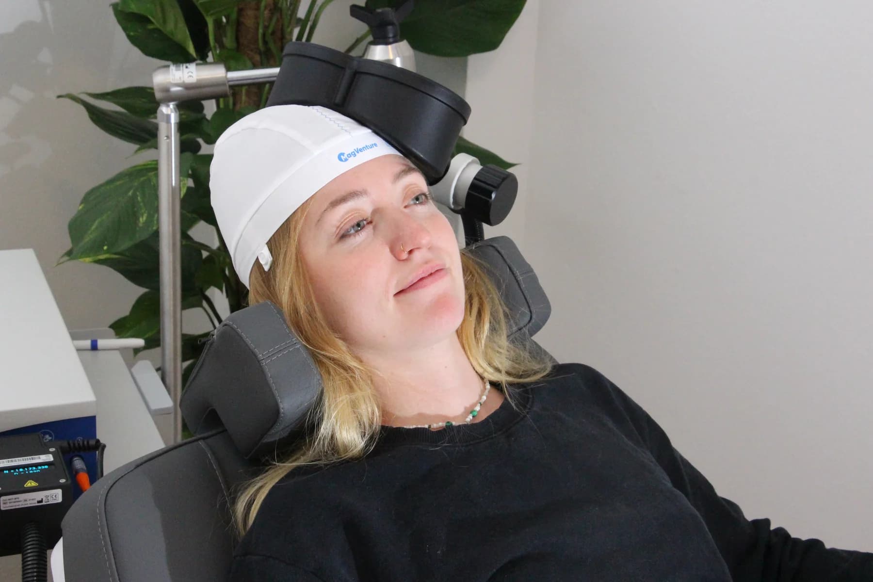 Patient wearing a stimulation cap during an rTMS session at the Praxis für Neurostimulation in Berlin