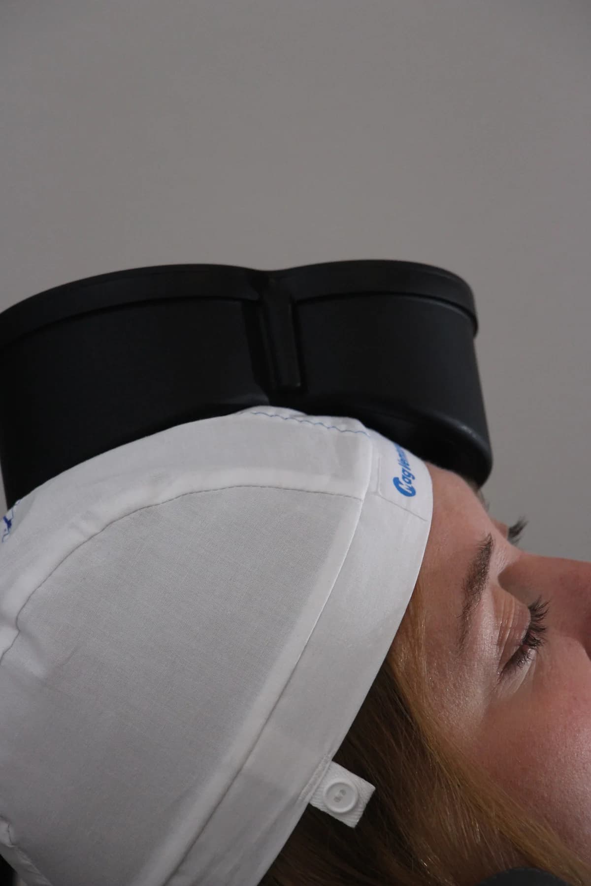 Close-up: the magnetic coil rests against the side of a patient's head